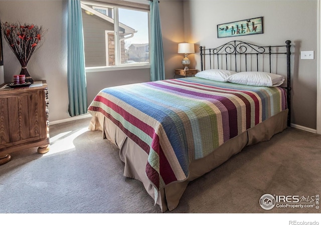 bedroom with carpet floors and baseboards
