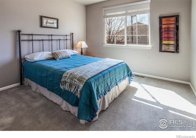 bedroom with carpet floors, baseboards, and visible vents