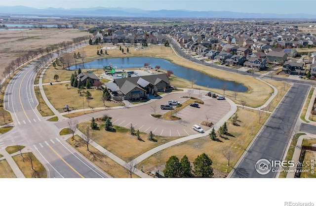 drone / aerial view with a residential view and a water and mountain view