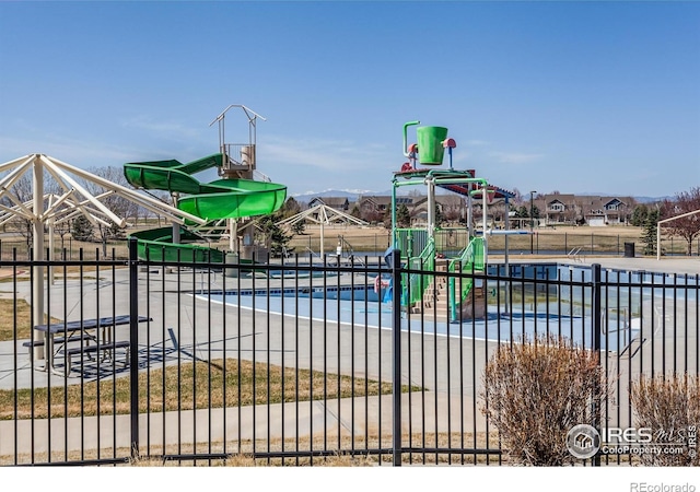 exterior space featuring fence and playground community