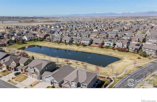 birds eye view of property featuring a water and mountain view and a residential view