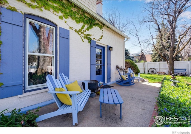 view of patio / terrace featuring fence
