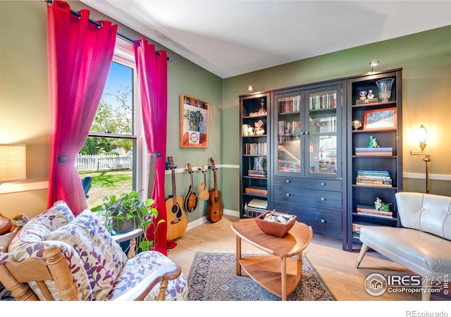 sitting room featuring baseboards and wood finished floors