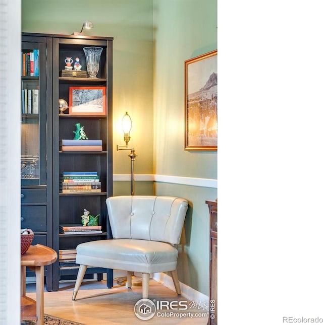 sitting room featuring baseboards and wood finished floors