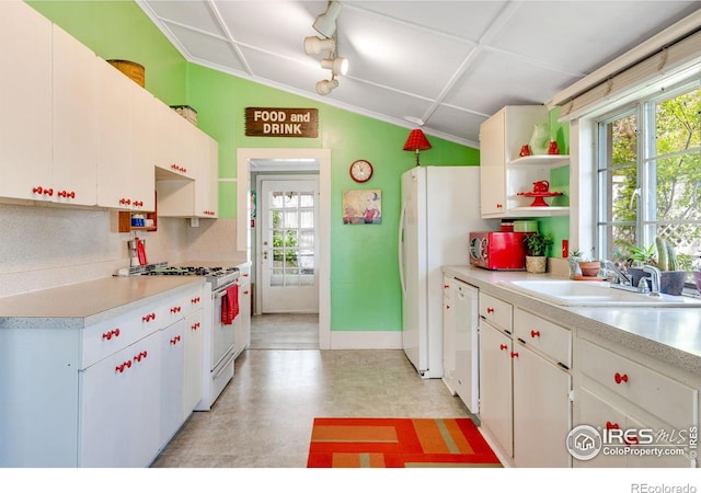 kitchen featuring open shelves, a sink, white appliances, light countertops, and white cabinetry
