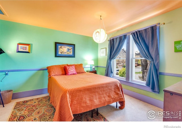 bedroom featuring carpet floors and baseboards
