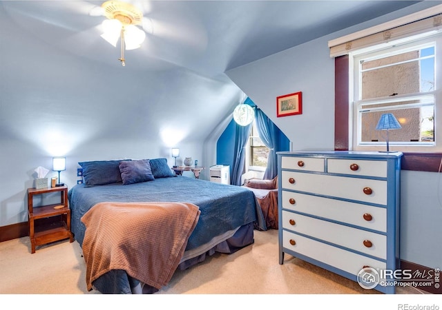 bedroom featuring carpet flooring, multiple windows, and lofted ceiling