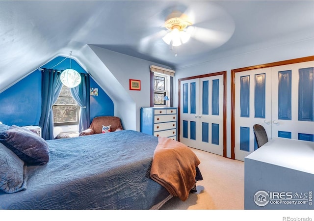 bedroom with carpet floors, multiple windows, multiple closets, and ceiling fan