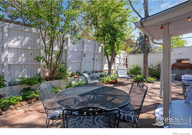 view of patio featuring fence and outdoor dining area