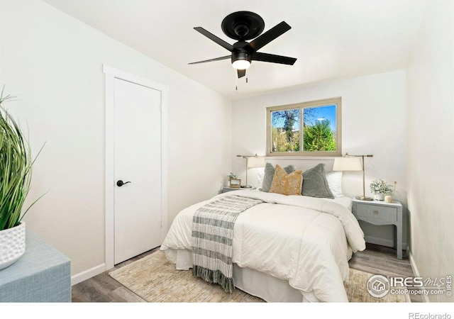 bedroom with baseboards, a ceiling fan, and wood finished floors
