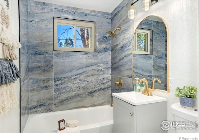 bathroom with vanity, toilet, and tub / shower combination