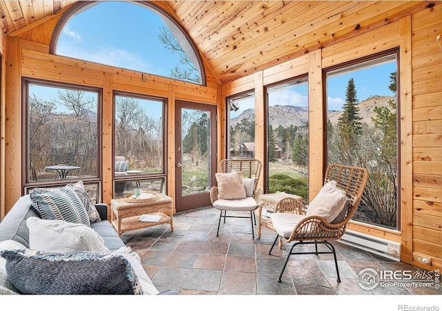 sunroom with stone tile flooring, lofted ceiling, wood ceiling, wooden walls, and baseboard heating