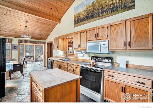 kitchen featuring white microwave, range with electric cooktop, black dishwasher, a sink, and stone tile floors