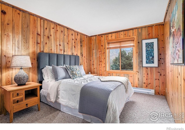 carpeted bedroom with baseboard heating and wooden walls