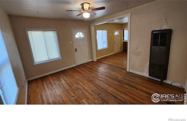 401 Park St, Sterling, CO 80751 - entryway featuring baseboards, a heating unit, a ceiling fan, and wood finished floors