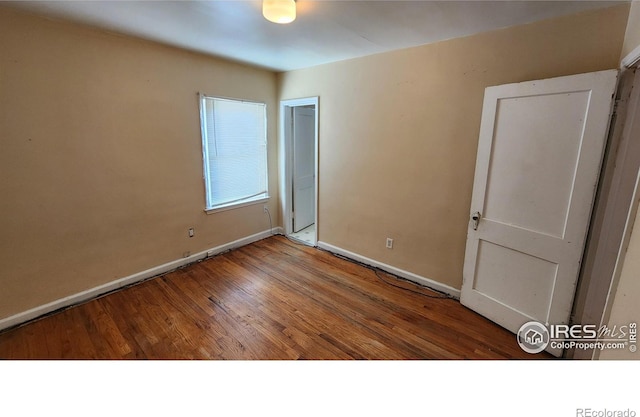 401 Park St, Sterling, CO 80751 - empty room featuring baseboards and wood finished floors