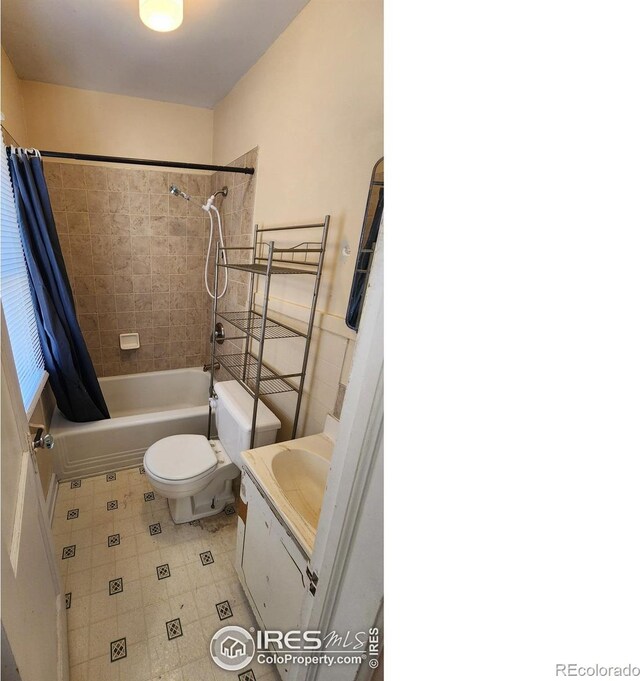 401 Park St, Sterling, CO 80751 - bathroom with toilet, shower / bath combination with curtain, tile patterned flooring, and vanity