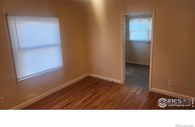 401 Park St, Sterling, CO 80751 - empty room featuring baseboards and wood finished floors
