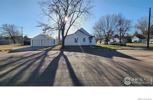 401 Park St, Sterling, CO 80751 - view of home's exterior with a garage, an outdoor structure, and a residential view