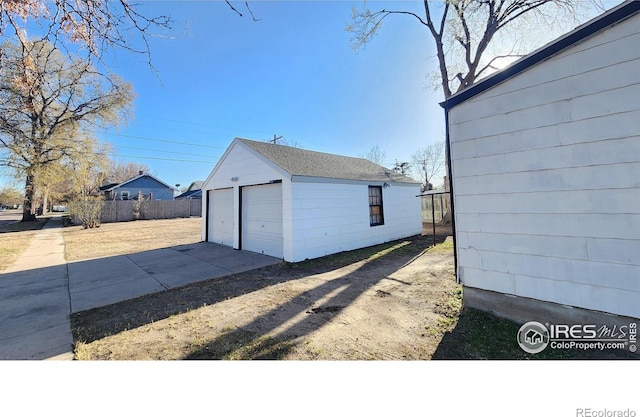 401 Park St, Sterling, CO 80751 - exterior space featuring an outdoor structure, fence, and a detached garage