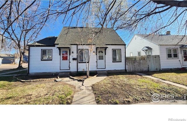 401 Park St, Sterling, CO 80751 - view of front facade with a shingled roof, fence, and entry steps