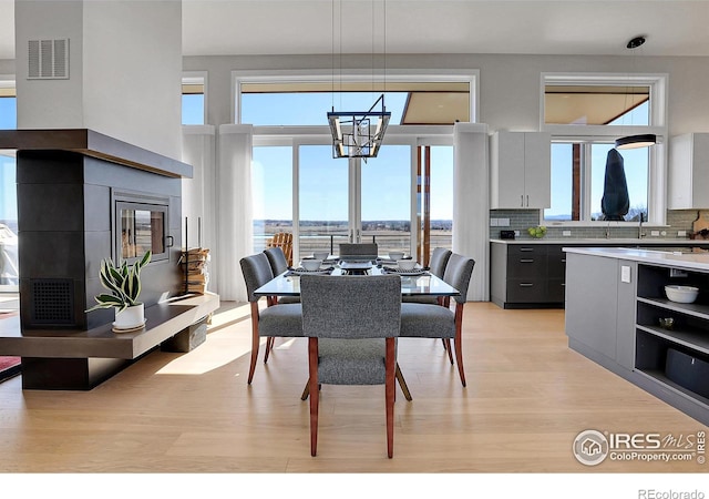11251 Lookout Dr, Longmont, CO 80504 - dining room featuring light wood finished floors and a chandelier
