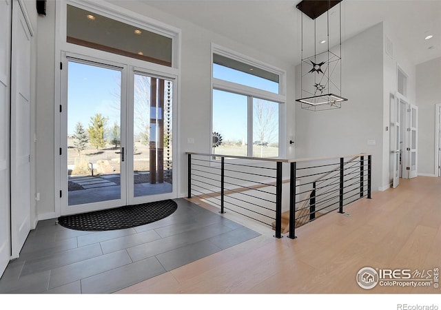 11251 Lookout Dr, Longmont, CO 80504 - foyer with a chandelier, wood finished floors, recessed lighting, baseboards, and a towering ceiling