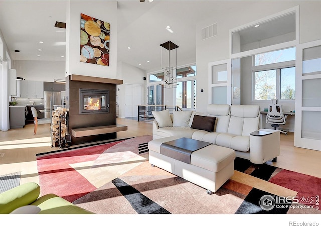 11251 Lookout Dr, Longmont, CO 80504 - living room with a towering ceiling, healthy amount of natural light, a multi sided fireplace, and recessed lighting