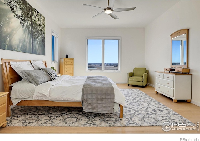 11251 Lookout Dr, Longmont, CO 80504 - bedroom featuring wood finished floors, a ceiling fan, and baseboards
