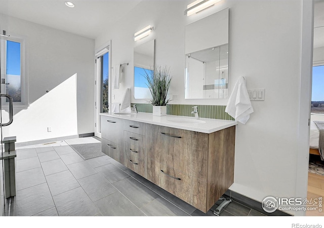 11251 Lookout Dr, Longmont, CO 80504 - full bath with ensuite bath, double vanity, recessed lighting, and baseboards
