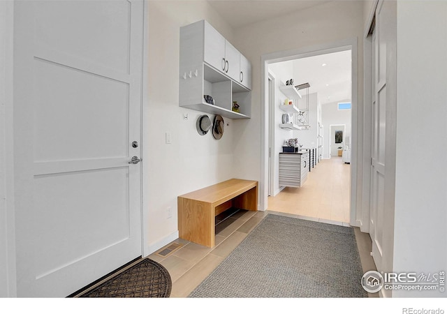 11251 Lookout Dr, Longmont, CO 80504 - mudroom with light tile patterned floors and baseboards