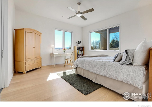 11251 Lookout Dr, Longmont, CO 80504 - bedroom featuring light wood finished floors, a ceiling fan, and baseboards