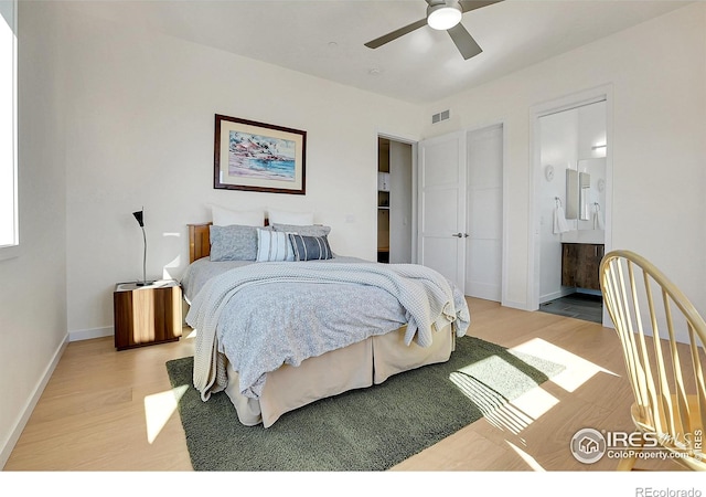 11251 Lookout Dr, Longmont, CO 80504 - bedroom with light wood finished floors, baseboards, connected bathroom, and a ceiling fan