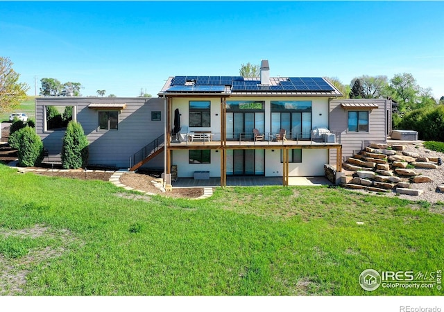 11251 Lookout Dr, Longmont, CO 80504 - rear view of property with a patio, solar panels, a chimney, a yard, and stucco siding