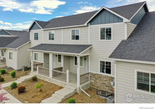 4355 24th Street Rd Unit 803, Greeley, CO 80634 - view of front of home with board and batten siding, covered porch, and roof with shingles