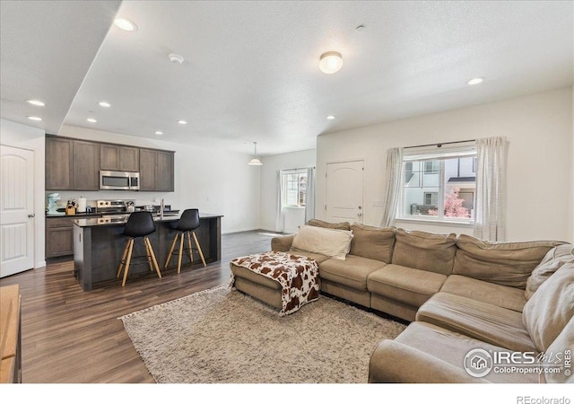 4355 24th Street Rd Unit 803, Greeley, CO 80634 - living room with baseboards, recessed lighting, and dark wood-style floors