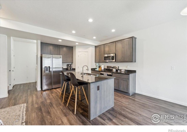 4355 24th Street Rd Unit 803, Greeley, CO 80634 - kitchen with dark countertops, appliances with stainless steel finishes, a sink, and dark wood-type flooring