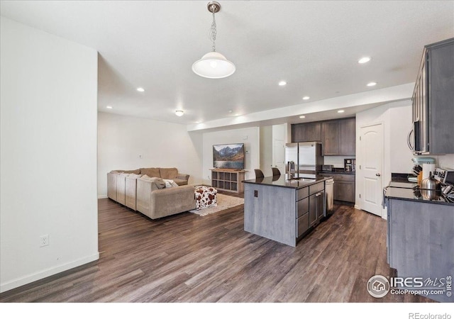 4355 24th Street Rd Unit 803, Greeley, CO 80634 - kitchen featuring dark countertops, open floor plan, recessed lighting, a sink, and appliances with stainless steel finishes