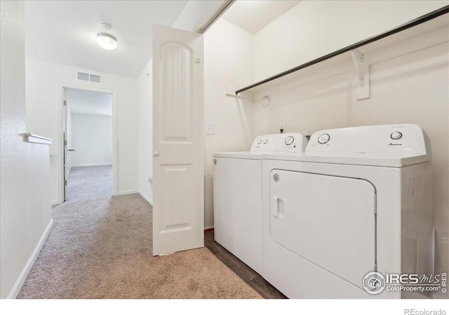 4355 24th Street Rd Unit 803, Greeley, CO 80634 - washroom featuring laundry area, light colored carpet, visible vents, baseboards, and washer and clothes dryer