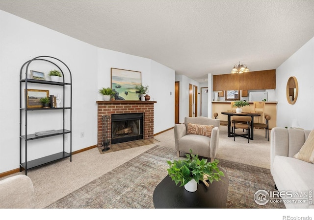 1231 W Swallow Rd Unit 314, Fort Collins, CO 80526 - carpeted living area featuring a textured ceiling and a fireplace