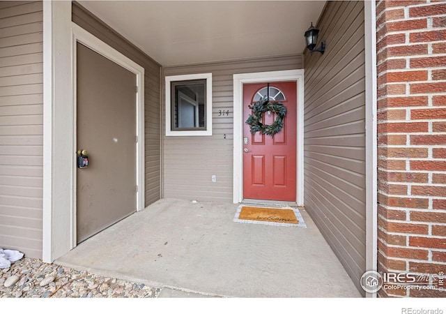 1231 W Swallow Rd Unit 314, Fort Collins, CO 80526 - doorway to property featuring brick siding