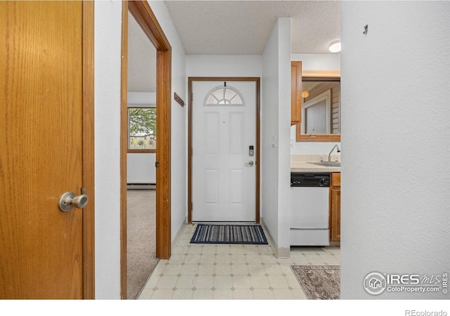 1231 W Swallow Rd Unit 314, Fort Collins, CO 80526 - foyer entrance featuring light floors, a baseboard radiator, and a textured ceiling