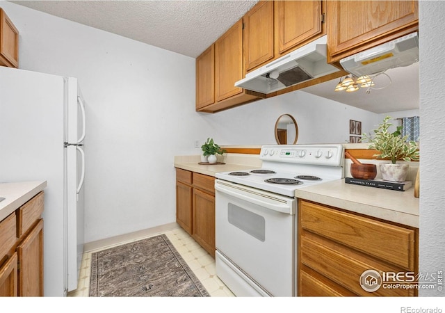 1231 W Swallow Rd Unit 314, Fort Collins, CO 80526 - kitchen with brown cabinetry, a textured ceiling, light countertops, light floors, and white appliances