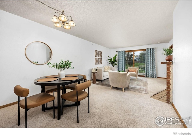 1231 W Swallow Rd Unit 314, Fort Collins, CO 80526 - carpeted dining room featuring a textured ceiling, a notable chandelier, and baseboards