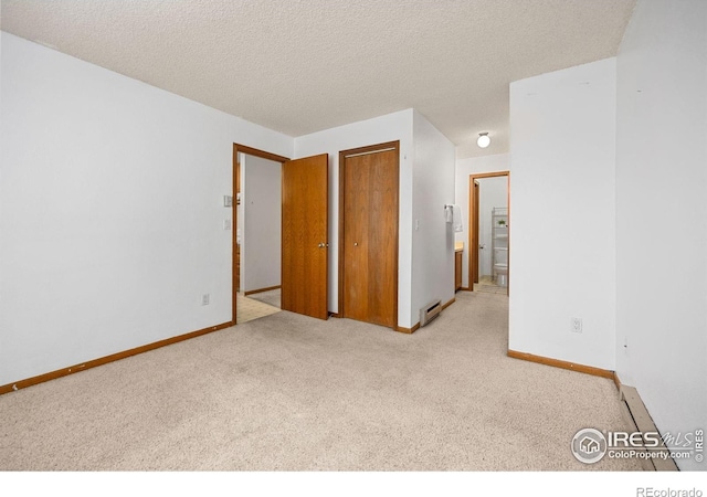 1231 W Swallow Rd Unit 314, Fort Collins, CO 80526 - unfurnished bedroom with baseboards, carpet flooring, ensuite bathroom, and a baseboard heating unit