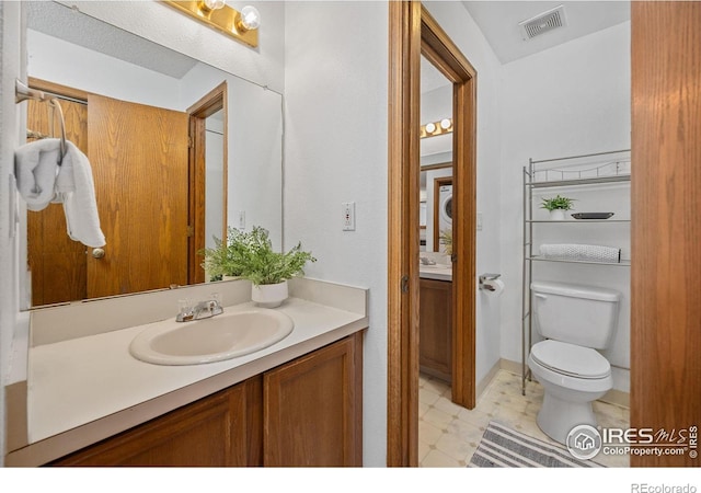 1231 W Swallow Rd Unit 314, Fort Collins, CO 80526 - bathroom with vanity, tile patterned floors, toilet, and visible vents