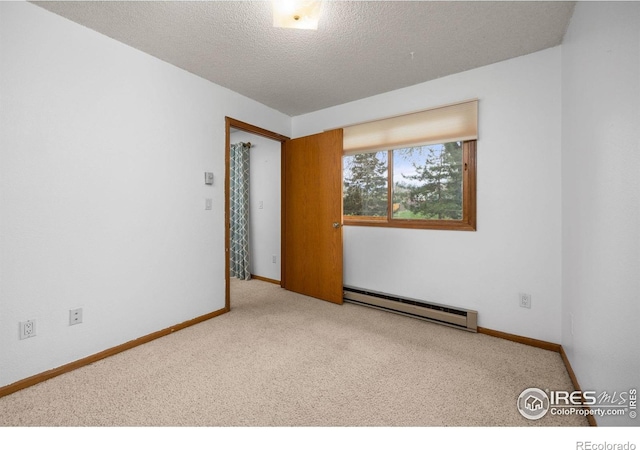 1231 W Swallow Rd Unit 314, Fort Collins, CO 80526 - carpeted empty room with baseboards, a textured ceiling, and baseboard heating