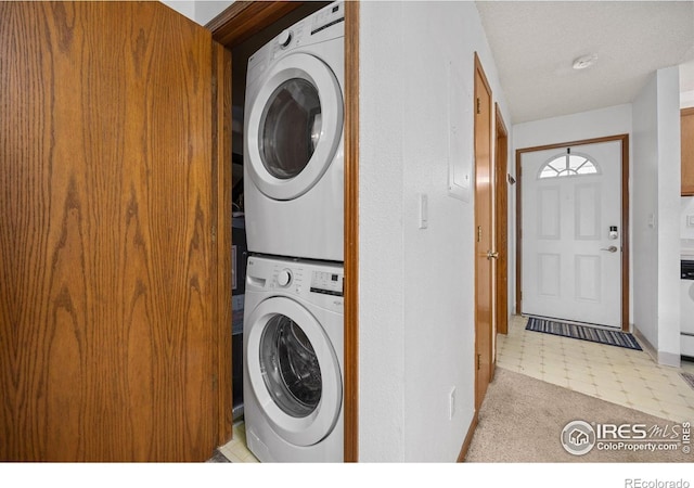 1231 W Swallow Rd Unit 314, Fort Collins, CO 80526 - laundry area featuring stacked washer and dryer and baseboards