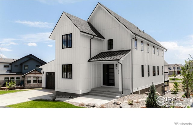 914 Eldorado Ln, Louisville, CO 80027 - view of front facade with a garage, roof with shingles, metal roof, a standing seam roof, and concrete driveway