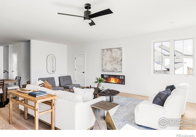 914 Eldorado Ln, Louisville, CO 80027 - living area with a ceiling fan, light wood-style flooring, and a glass covered fireplace